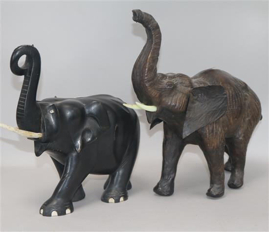A carved ebony elephant and another